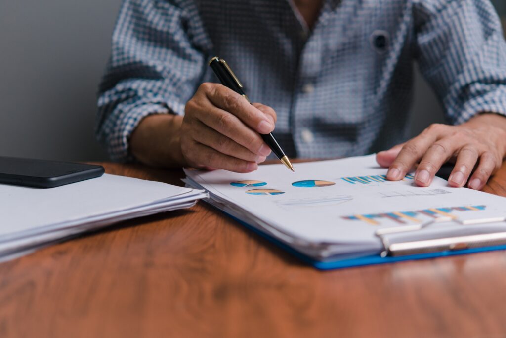 Businessman analyzing business planning, strategy, marketing and financial reports Hand Holding File