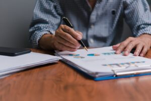 Businessman analyzing business planning, strategy, marketing and financial reports Hand Holding File