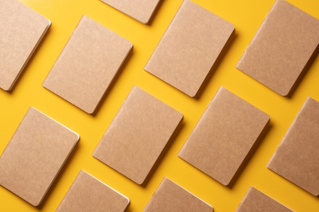 creativity content marketing concept,.top view of kraft notebook align in pattern on yellow table