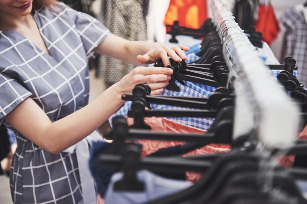 Young beautiful women at the weekly cloth market - Best friends sharing free time having fun and